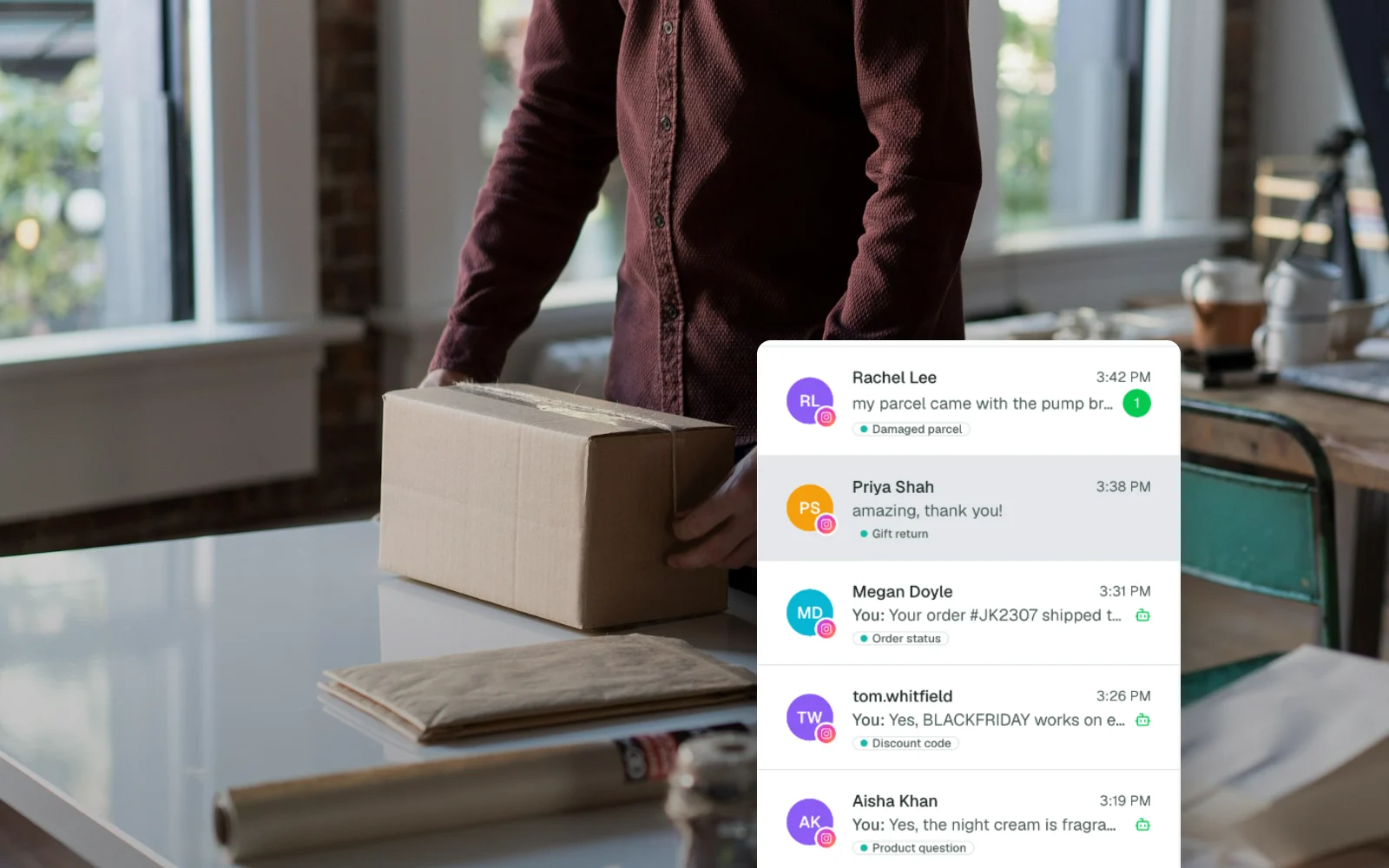 A person taping a parcel at a packing table, with the Support Fabric chat list in front showing Black Friday Instagram chats answered by the AI agent and labeled for the team (demo store Juniper & Kohl, recreated with demo data).